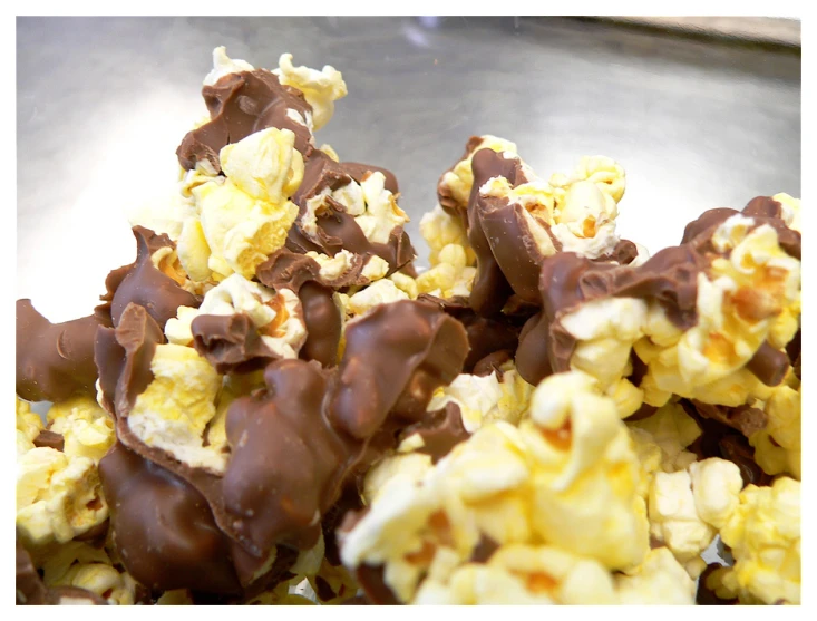 chocolate covered popcorn and candy coated nuts on top