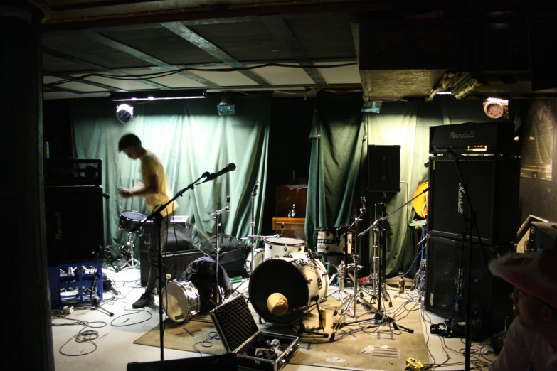 a recording room with lots of instruments, light, and curtain