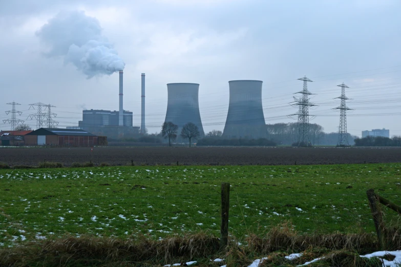 a factory building with smoke stacks in the distance