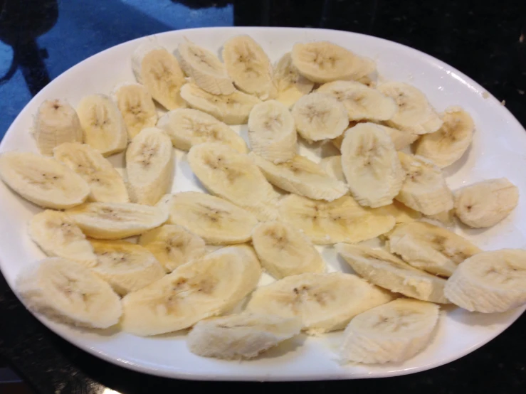 a bunch of bananas on a white plate