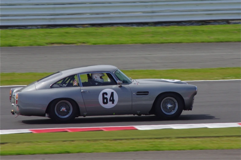 an old car speeds along a track