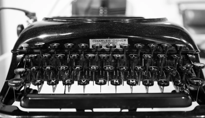 an antique typewriter with many keys and words on it