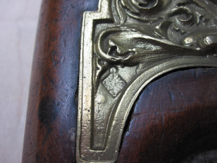 closeup of a wooden chair with metal designs on it