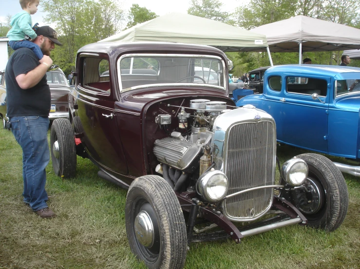 an older car with a baby riding on the front