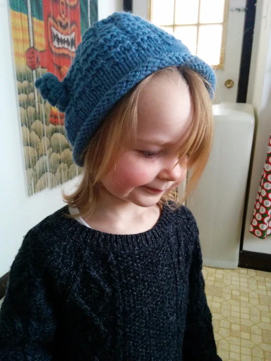 a little girl that is wearing a knit hat