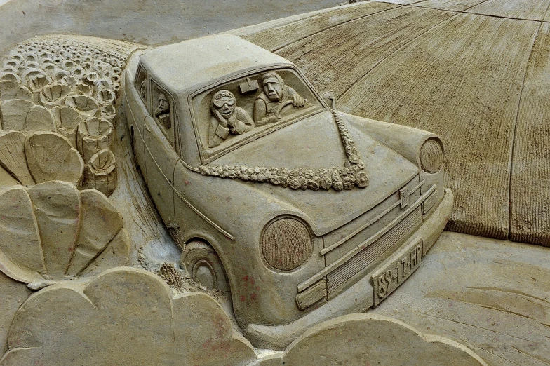 a sandy beach with a car on top