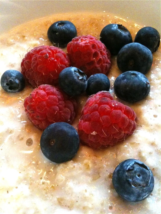 berries are piled up on top of the oatmeal