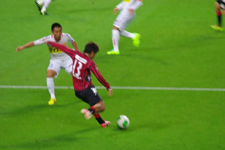 the soccer players are playing soccer on a field