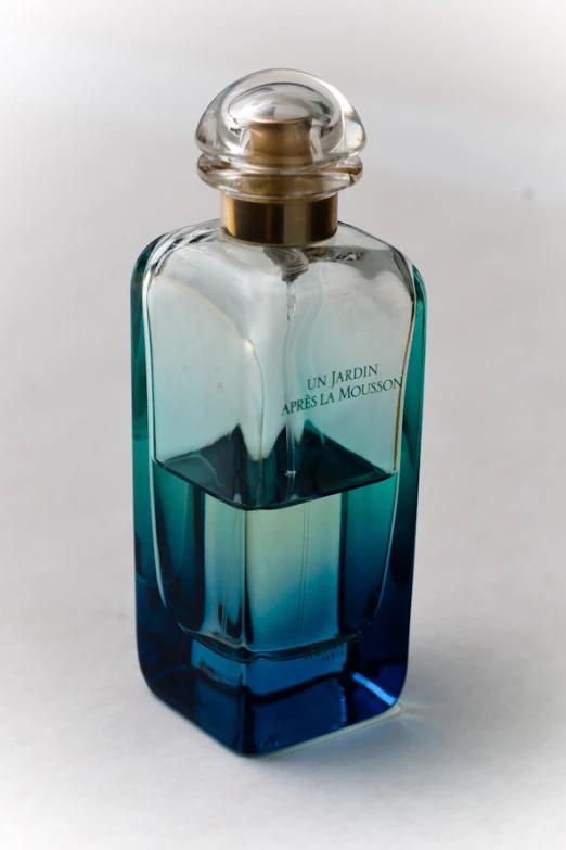 an empty bottle of perfume sitting on the table
