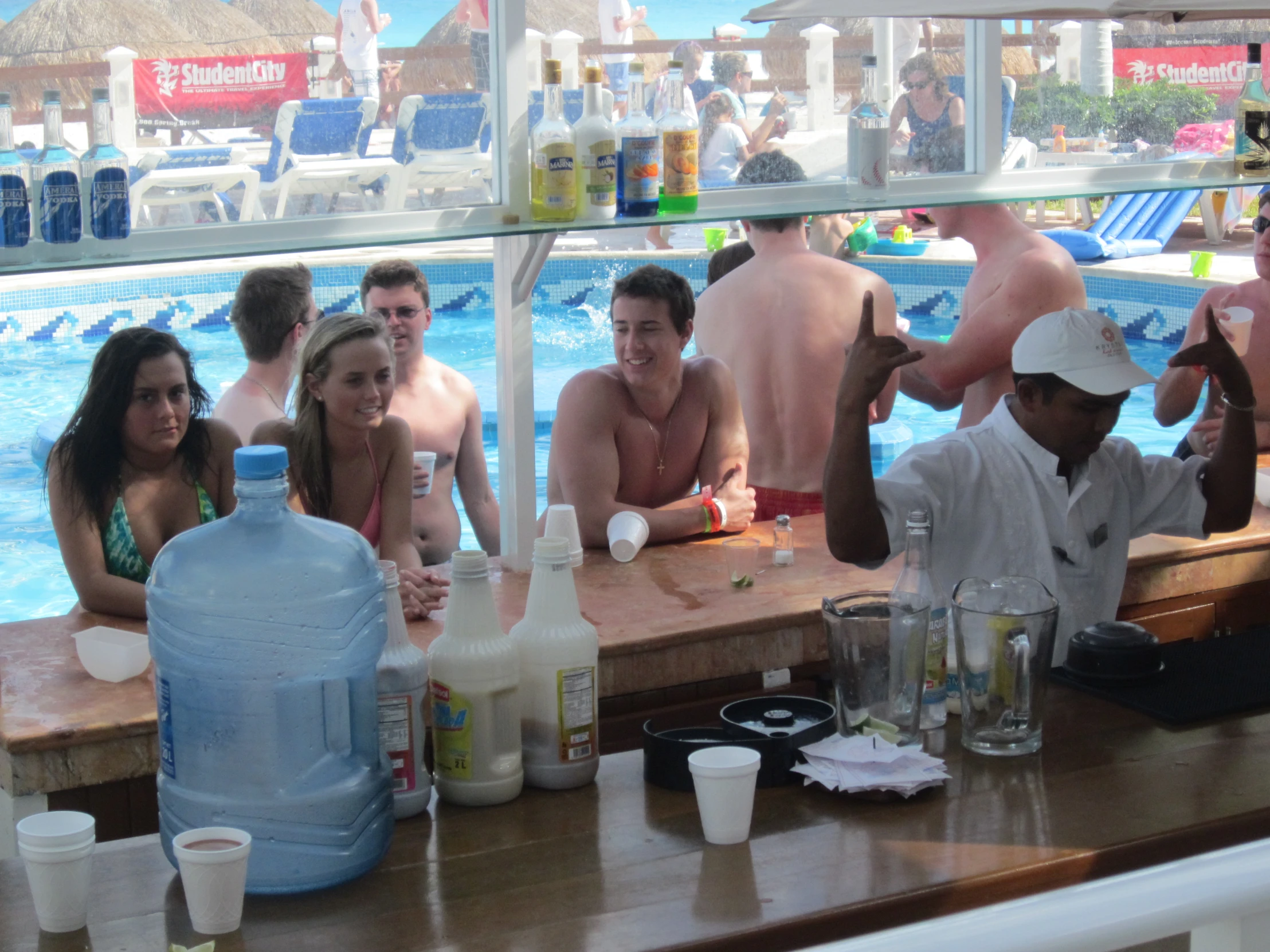 a group of people sitting next to each other by a swimming pool