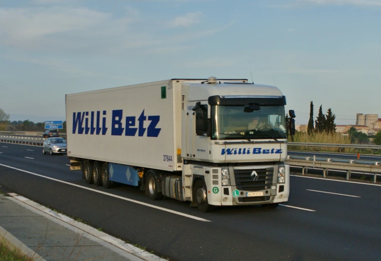 a white semi truck driving down the road