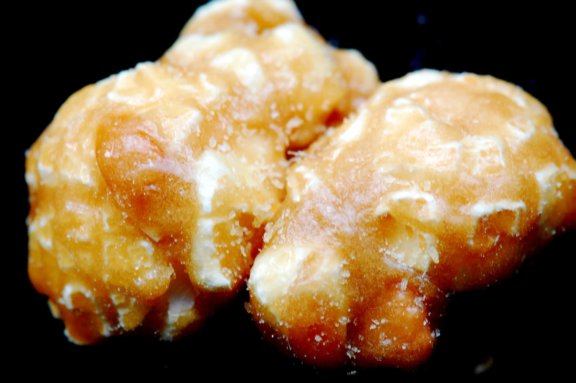 a closeup view of three doughnuts with icing on them