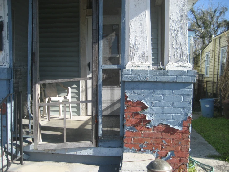 a porch in front of a house with the door ed open