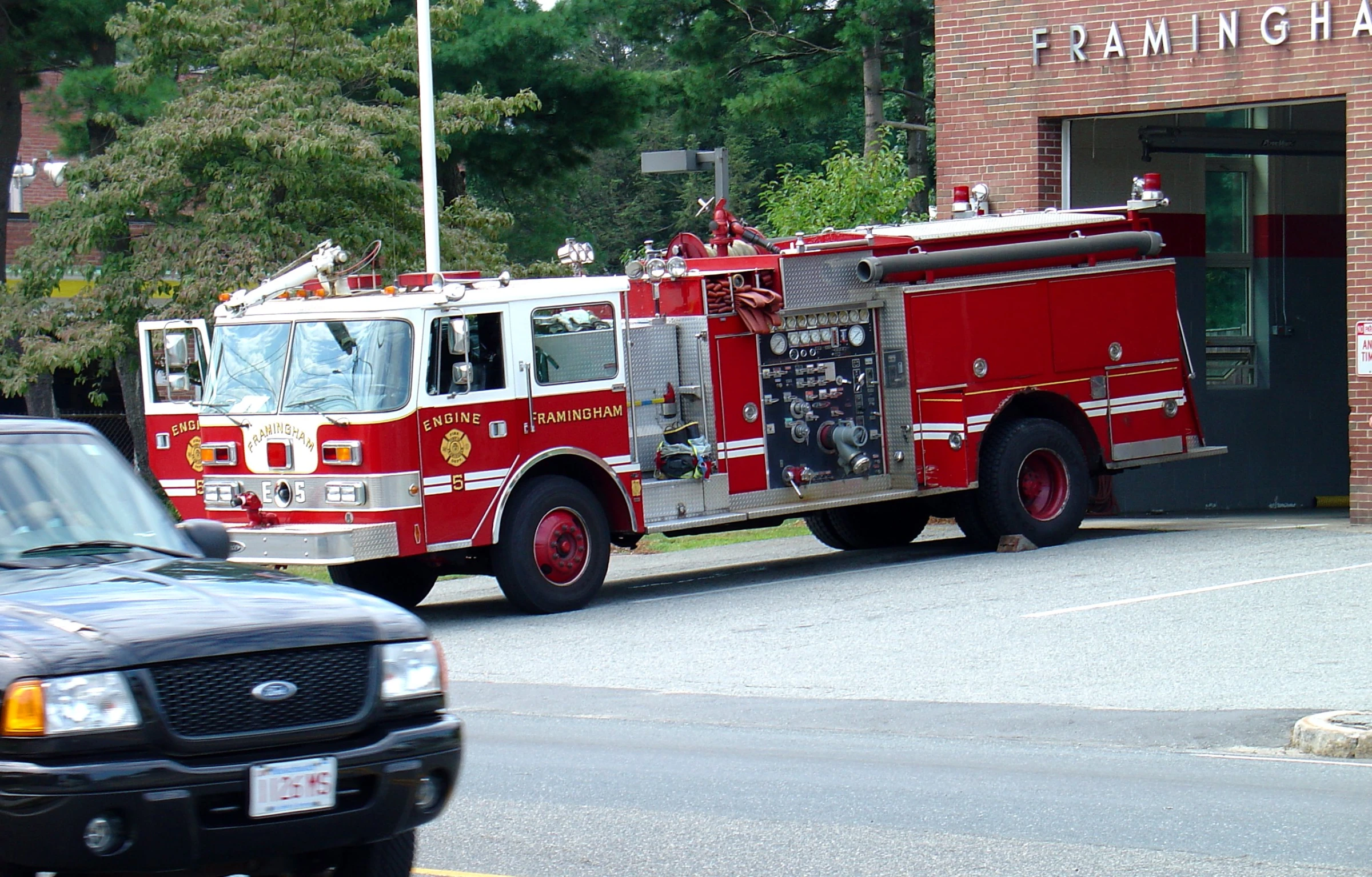 a firetruck is parked outside of an apartment building