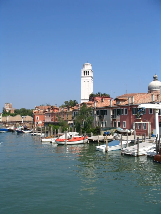 a city with lots of boats floating along side of a marina