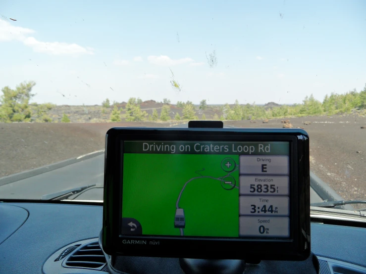 a gps function in a vehicle shows a track with cars and mountains