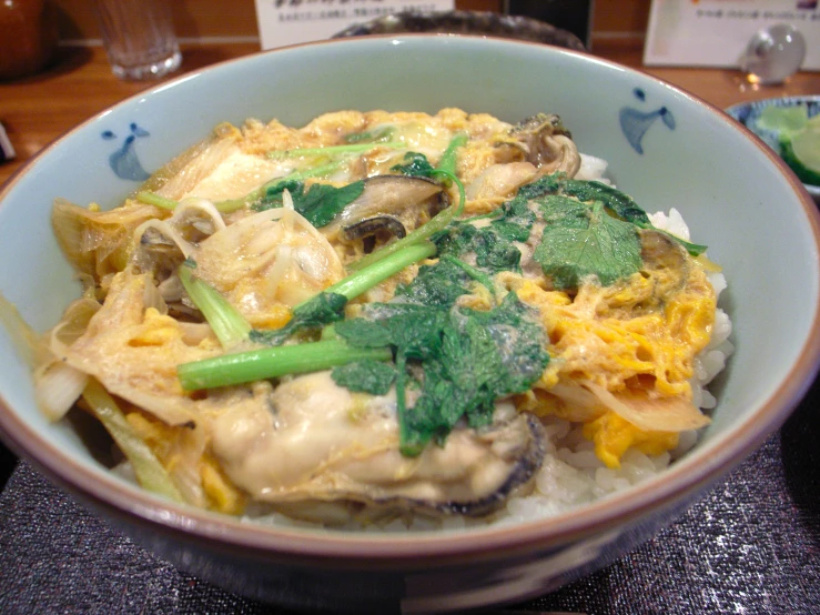 a bowl of food on a table with a wooden spoon