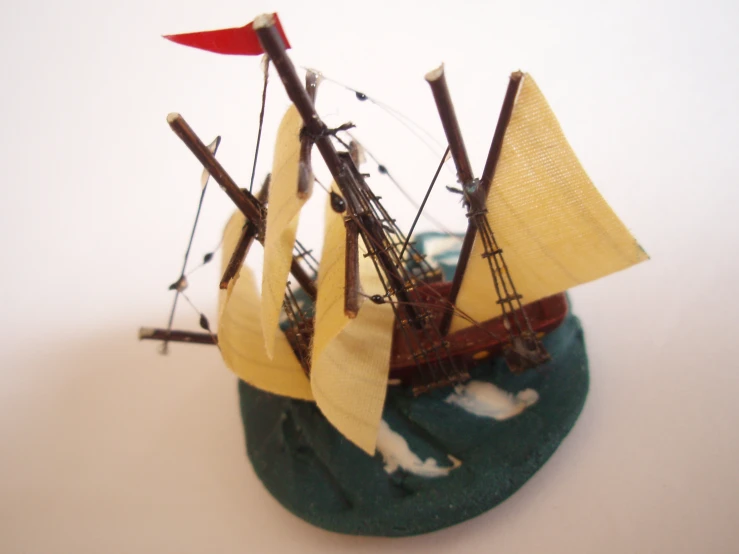 a small model pirate ship sailing on water
