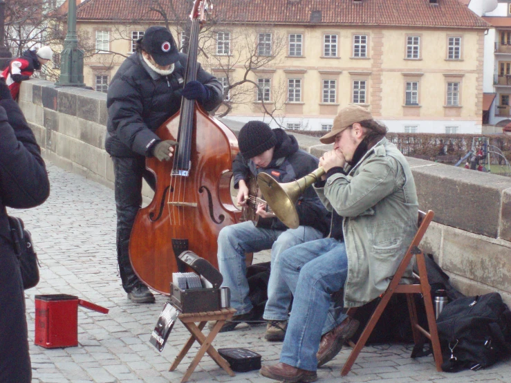 people playing musical instruments next to a person dressed as an animal