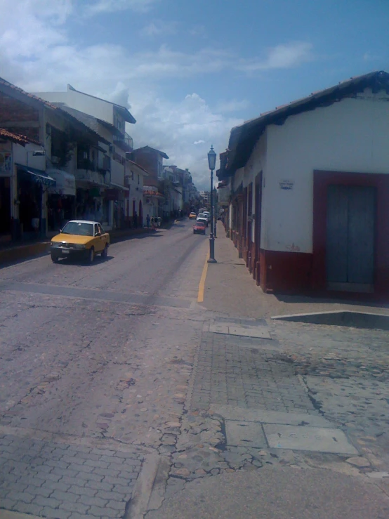 a blurry picture of a yellow car in the street