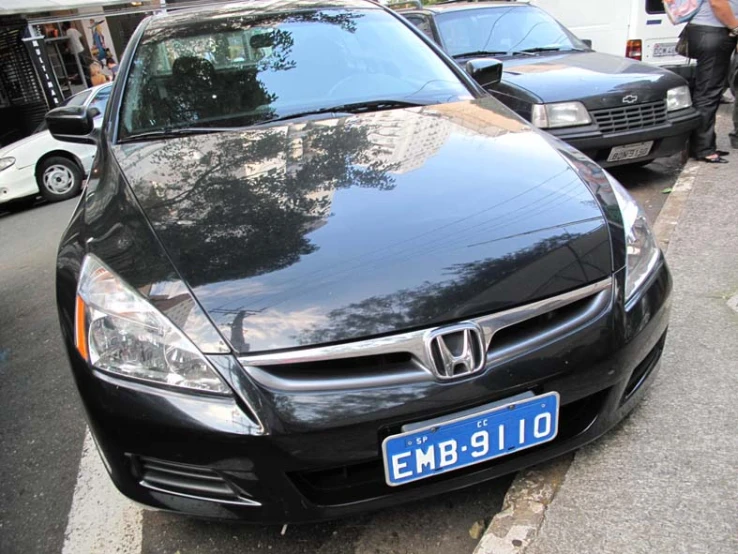 two cars in parking spaces next to a curb