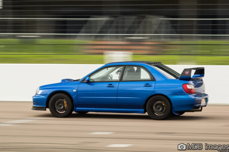 a blue car traveling down a race track