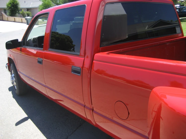 a red pick - up truck parked in a parking lot