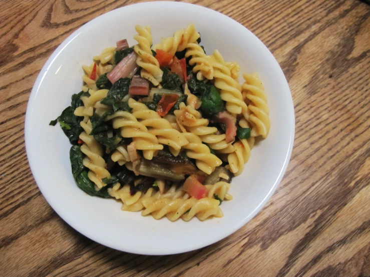 a plate with pasta, broccoli and sausage