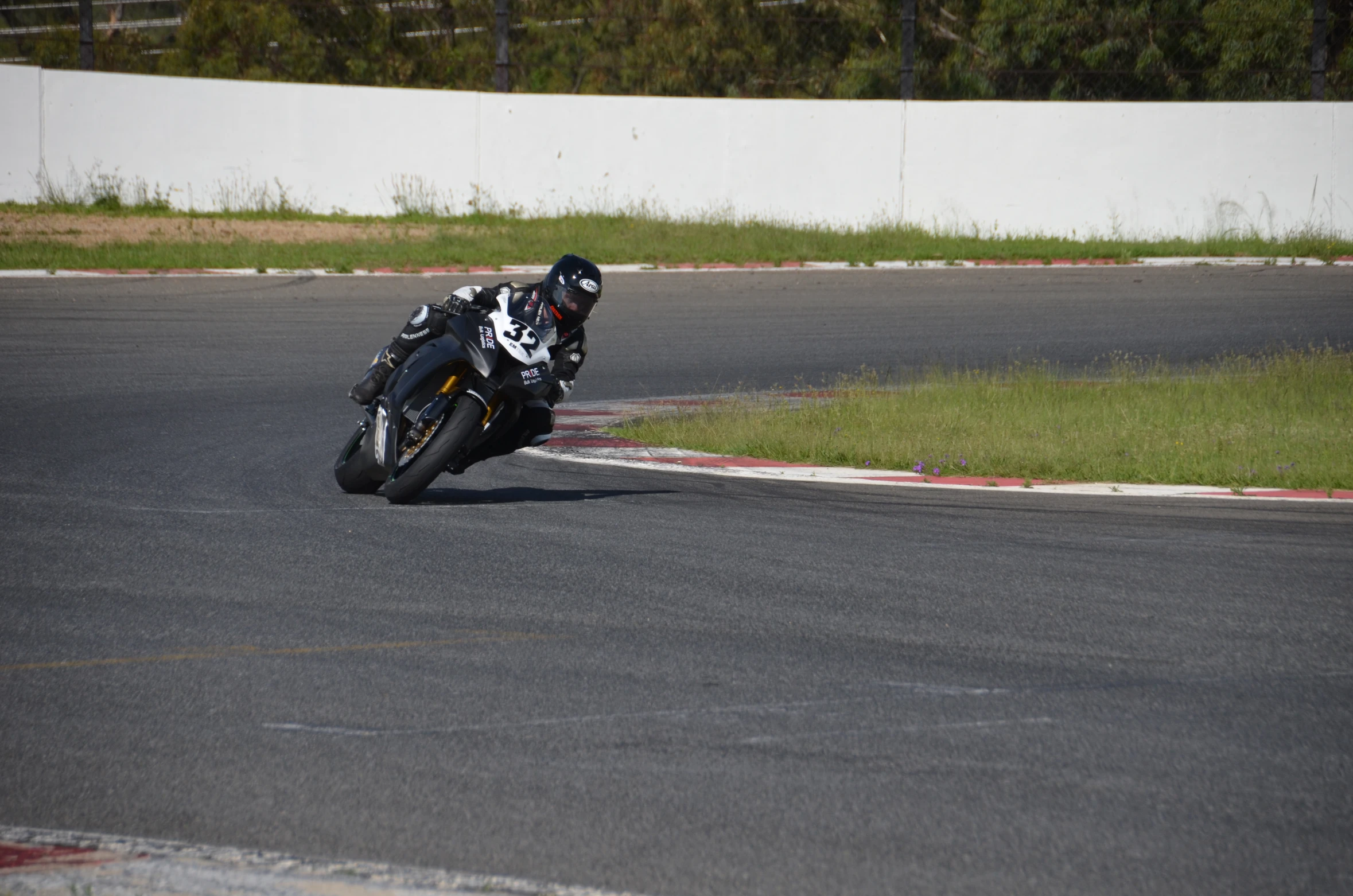 a motorcyclist is riding down the street in a curve