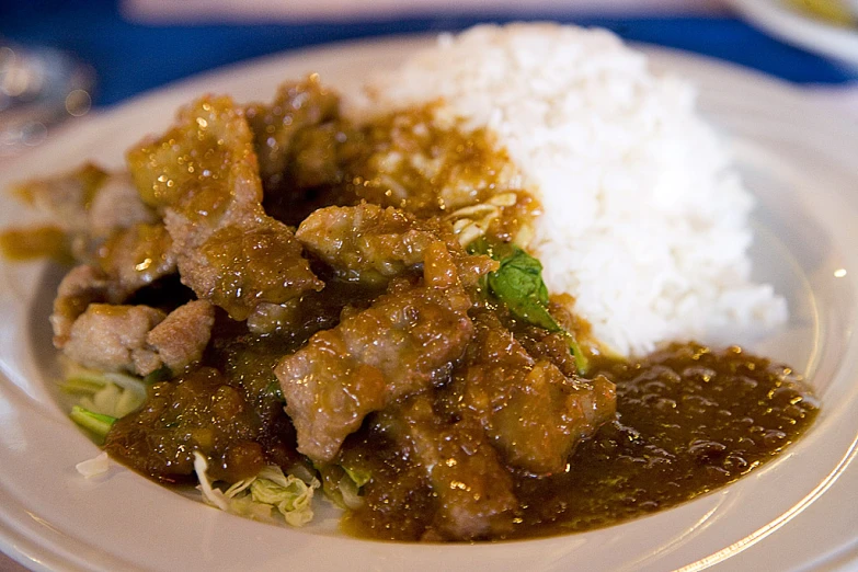 food is sitting on a white plate with some sauce