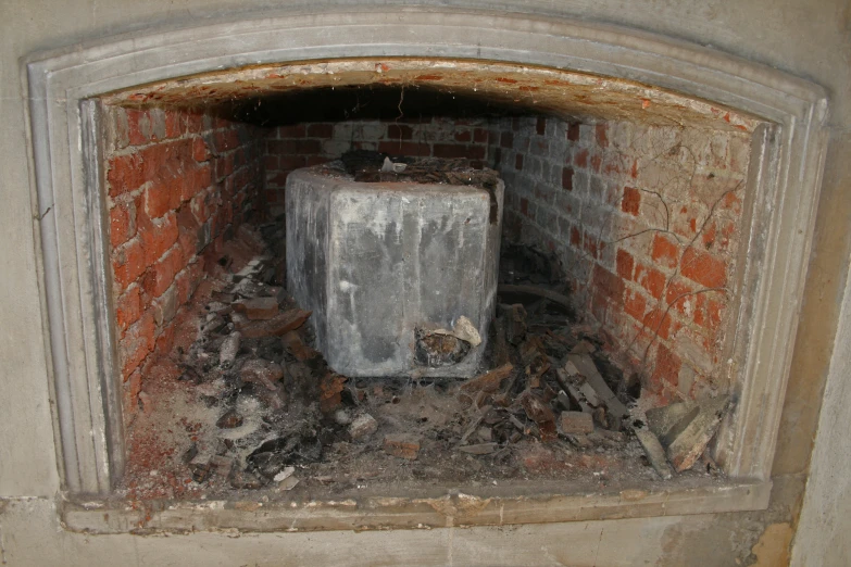 a brick fireplace with the door open and soing in it