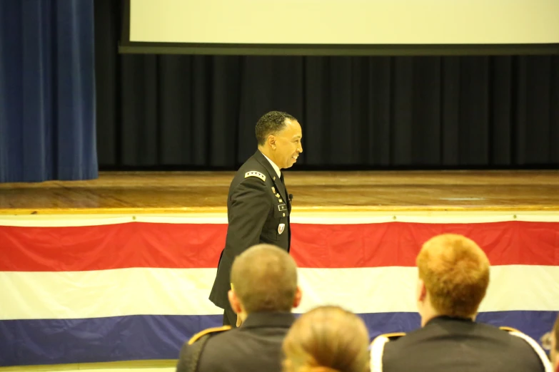 a man in a military uniform walking through a room