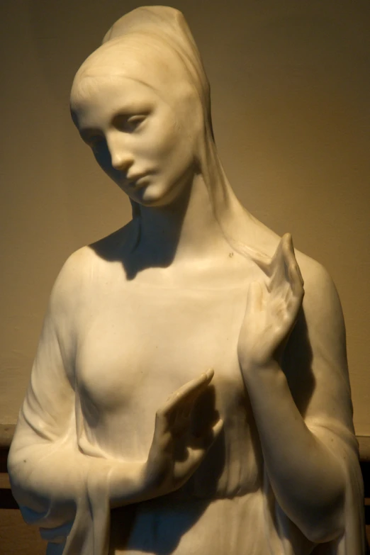 a marble statue of a woman holding a small object