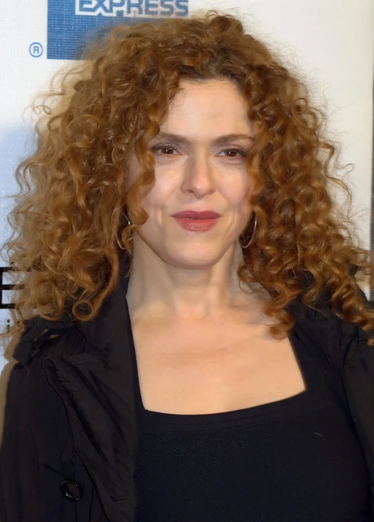 a person with big curly hair is posing