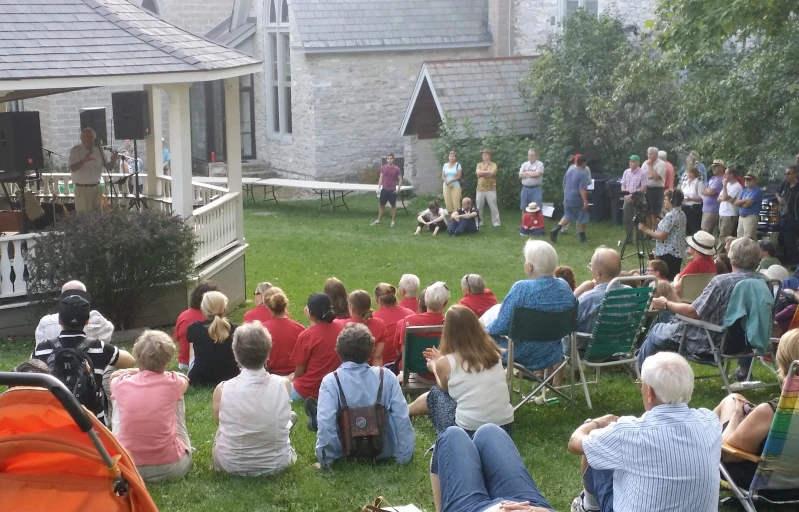 a crowd of people sitting in lawn chairs