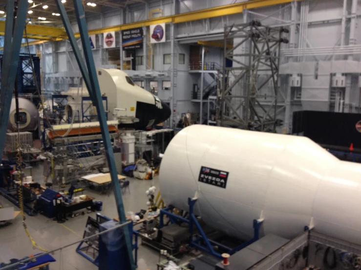 a white airplane is being built at a factory