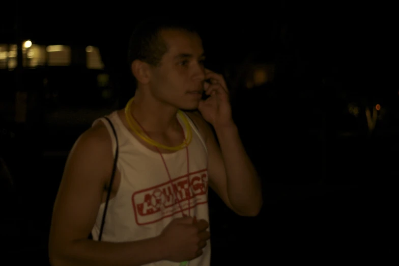 a man in white shirt holding up a phone