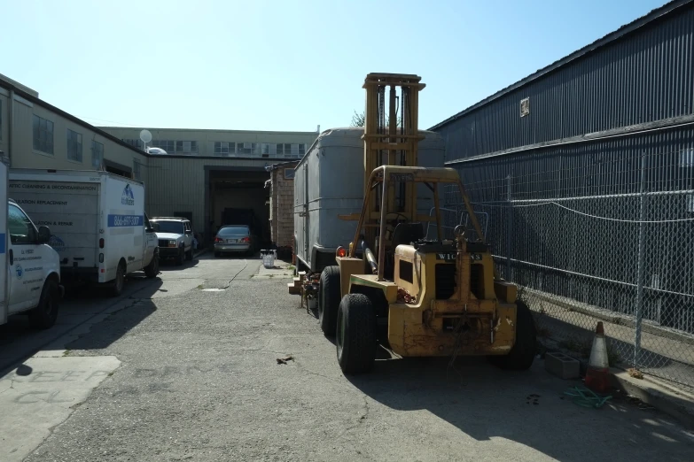 a forklift sitting in an open parking lot