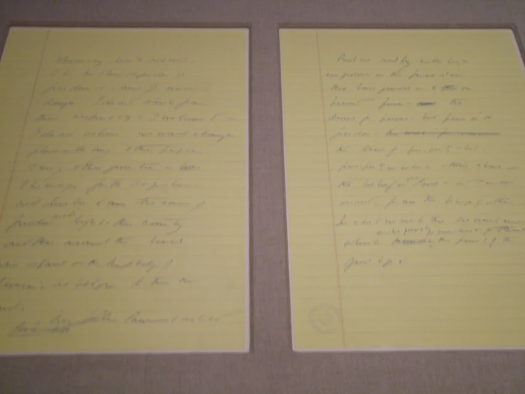 two yellow paper divider papers have handwriting on it