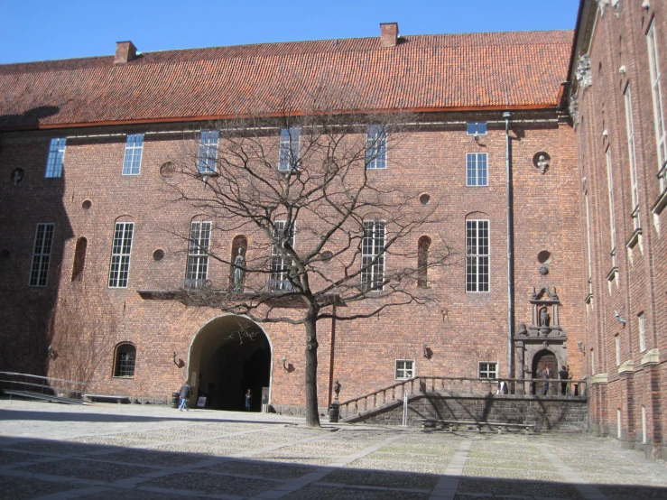 a brick building with several windows and stairs