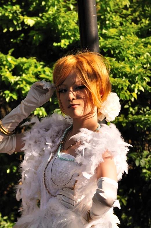 a woman wearing feathery attire next to a black lamp