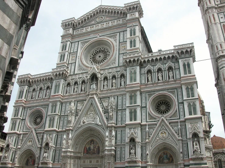 the cathedral has many very fancy windows with beautiful architecture