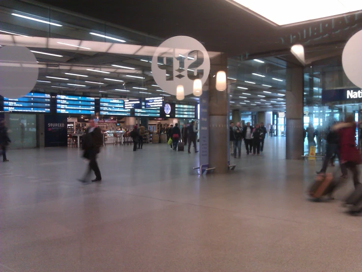 people inside a busy terminal with lights on