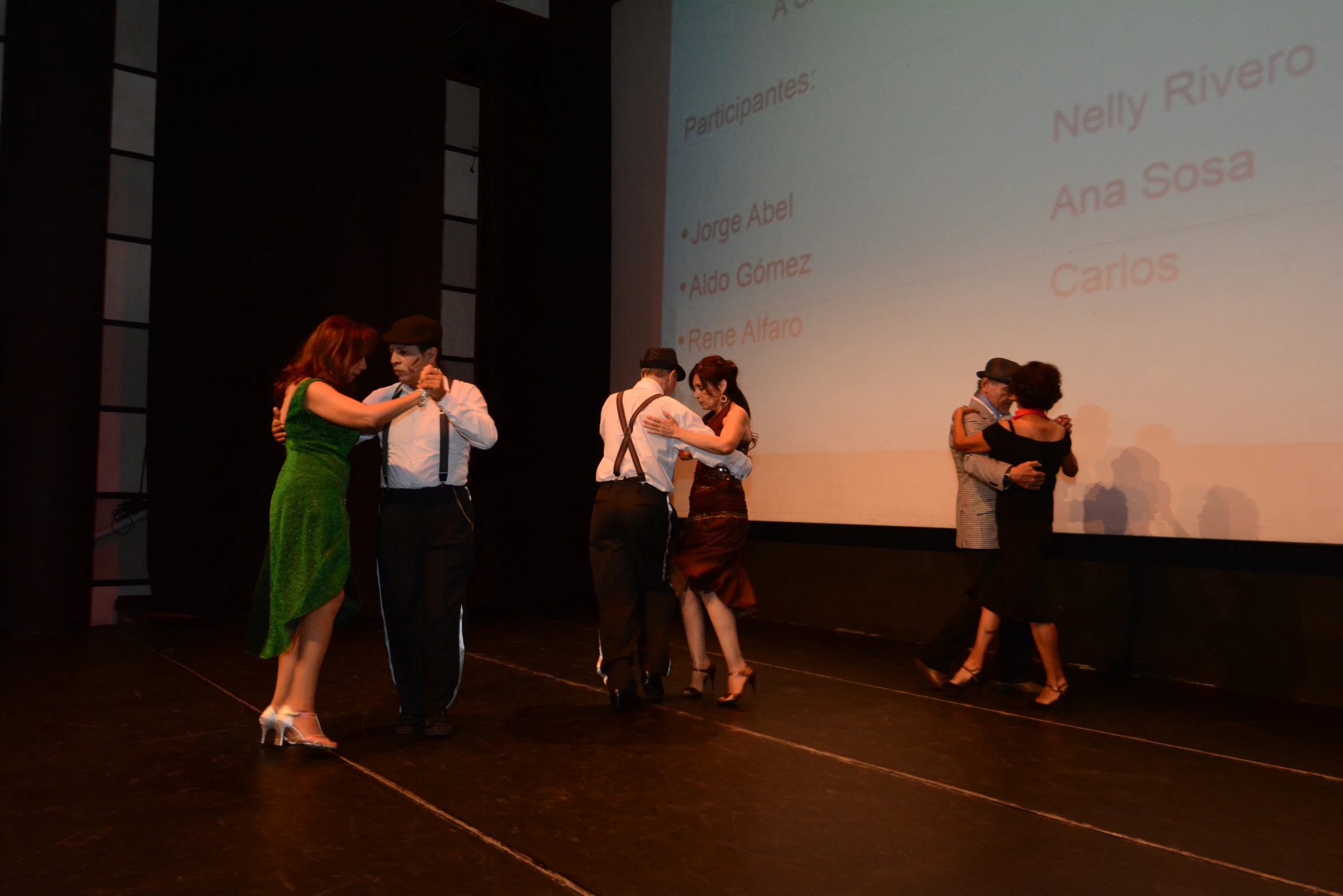 people standing around together hugging on stage