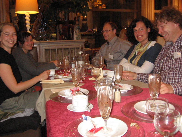 there are people at the table enjoying wine