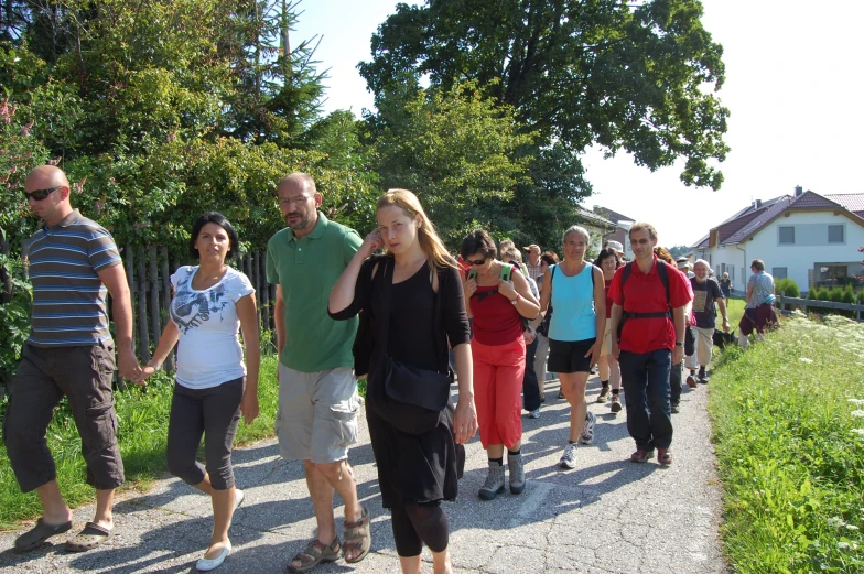 a large group of people walking on a path