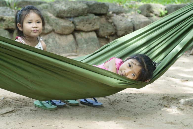 two children with one resting in a hammock