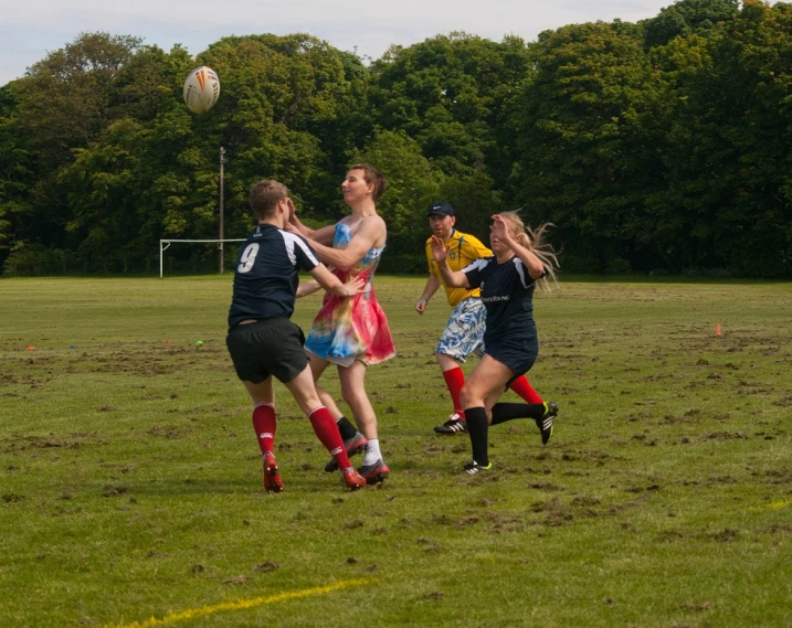 a group of people play a game on a soccer field