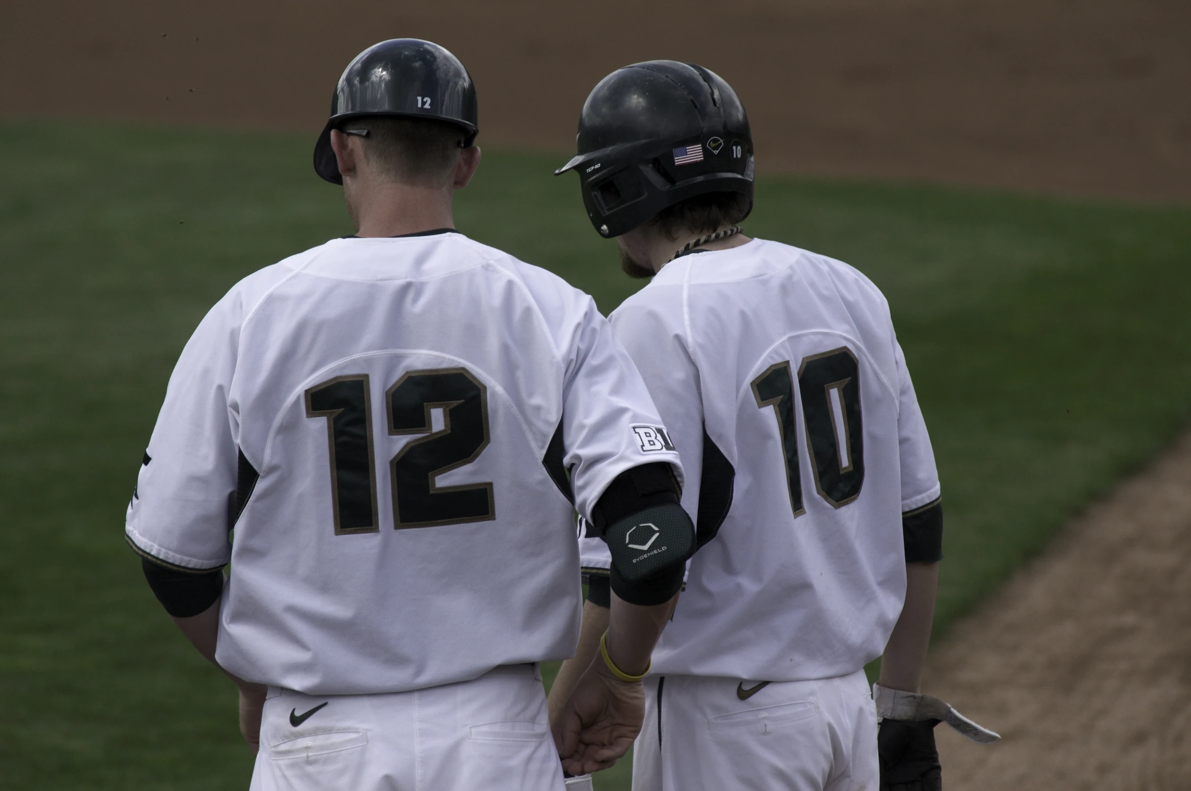 two baseball players shaking hands on a baseball field