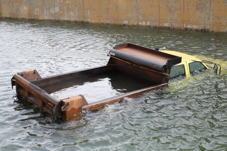 a truck with the doors open, and its front end is in some water